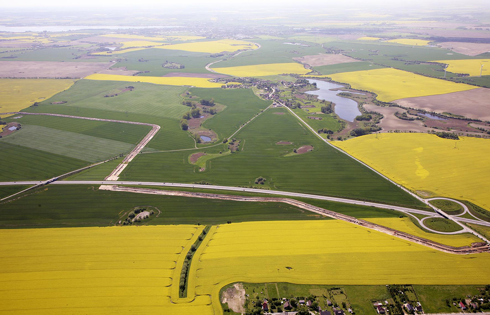 Abb. 2: Blick aus östlicher Richtung auf die A 20 mit der OPAL-Bautrasse im Mai 2010, im Hintergrund Baumgarten und Baumgartener See sowie auf der rechten Seite die Anschlussstelle Prenzlau-Ost.